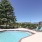 Pool with sundeck facing the mountains and trees