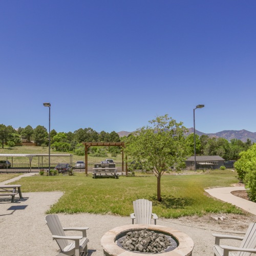 Firepit with four chairs and view of the mountains